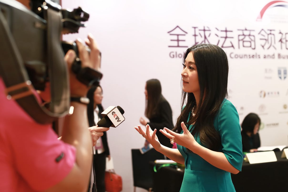 Angel Yingjun WANG (Chairperson of CILACEC, Legal Guru Club) is being interviewed by a CCTV 2 journalist